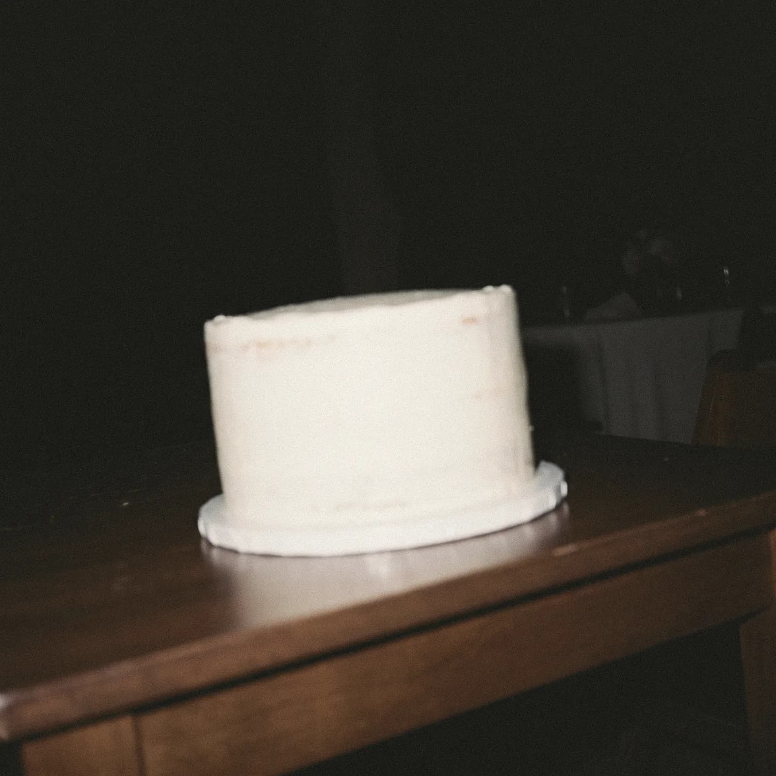 Una rebanada de pastel de bodas a medio comer en un plato de papel